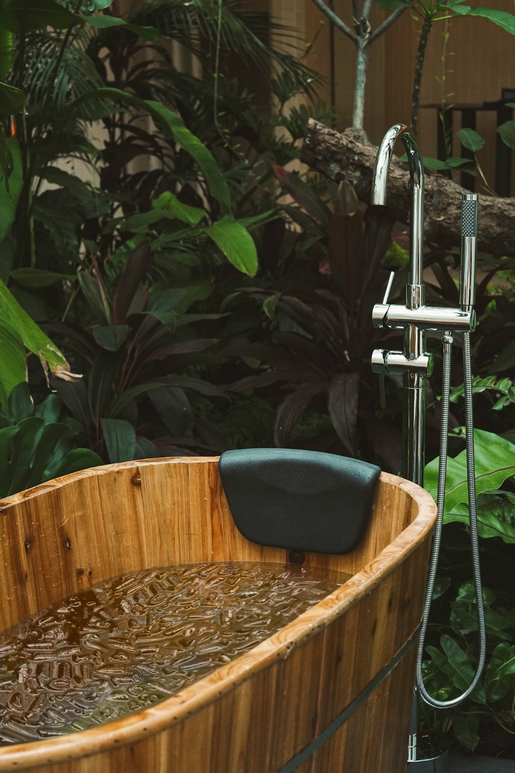 A wooden bathtub with water in it AI-generated content may be incorrect.